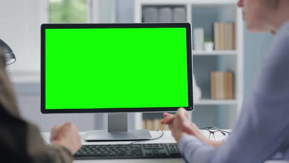 Women Using Chroma Key Computer