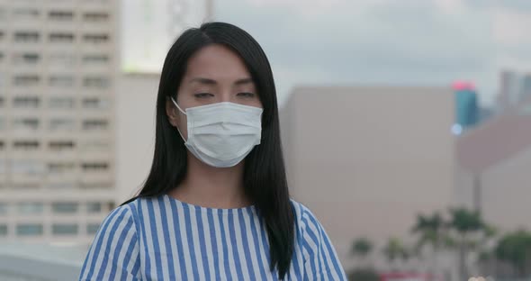 Woman wear face mask and look at camera 