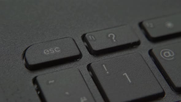 Finger Presses Escape Button on Keyboard.