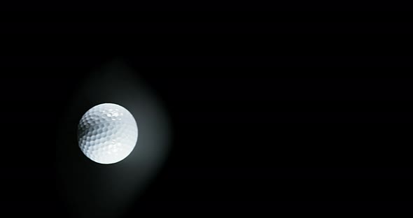 Golf's Ball against Black background, slow motion 4K