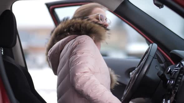 The Girl in the Jacket and Glasses Sits in the Car Starts It and Leaves  Slow Mo