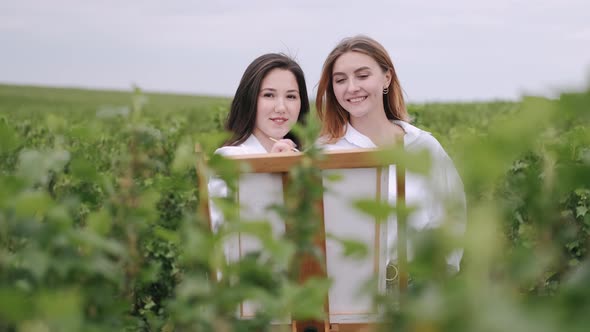 Elegant and Beautiful Girls Painting in a Field