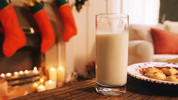 Gingerbread cookies with a glass of milk on wooden table