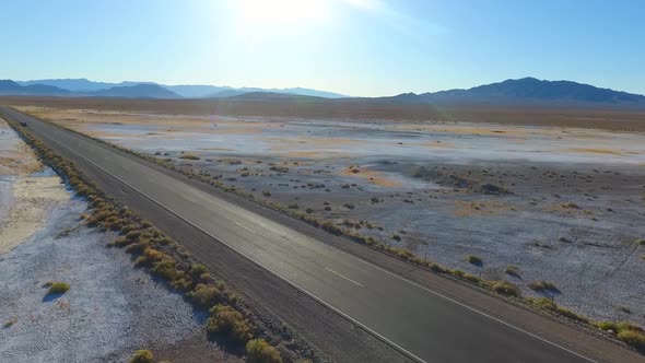 Border of Nevada and California Along White Sandy Desert Road with Distant Mountains