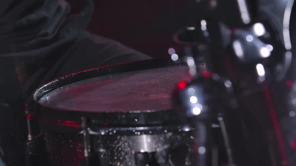 Man's Hands Hit the Drums Creating a Lot of Splashes