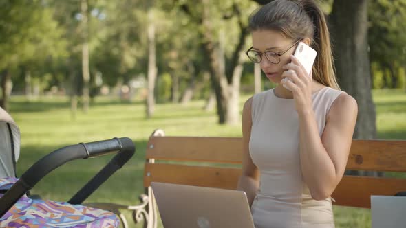 Middle Shot Portrait of Confident Focused Young Businesswoman Talking on the Phone, Surfing Internet