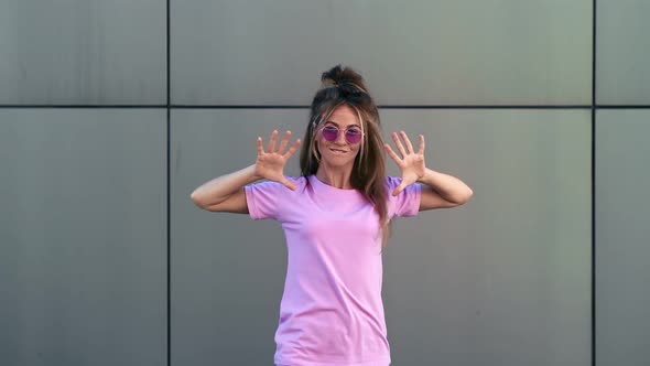 Female Dancer in Pink Summer Outfit Dancing at Metallic Wall