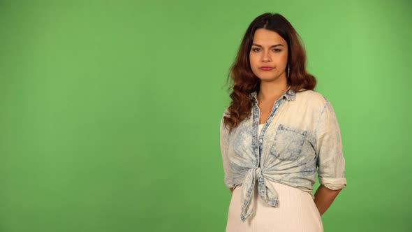 A Young Beautiful Caucasian Woman Shakes Her Head at the Camera  Green Screen Background