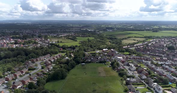 Left to right aerial shot above town near Wrexham, North Wales