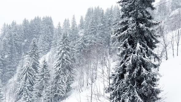 Cabins of Ski Lift Move on the Rope Way During Heavy Snowfall