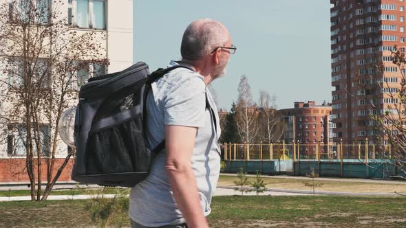 Man is hiking with his cat in bacpack