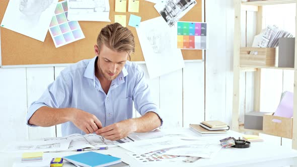 Young Confident Architector Checking Drawings Raving About at Workplace