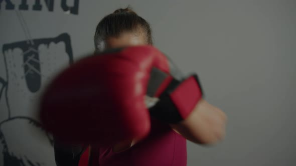Athletic woman boxing in the gym