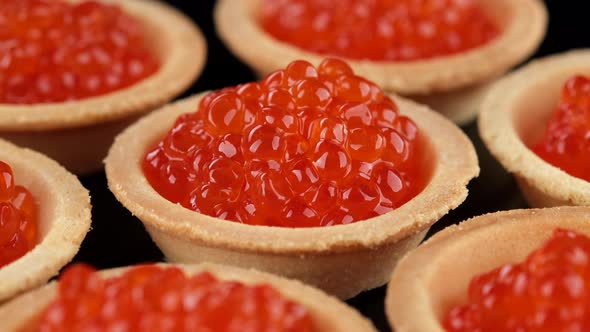 Tartlets with red caviar close-up, rotation. 4K UHD video