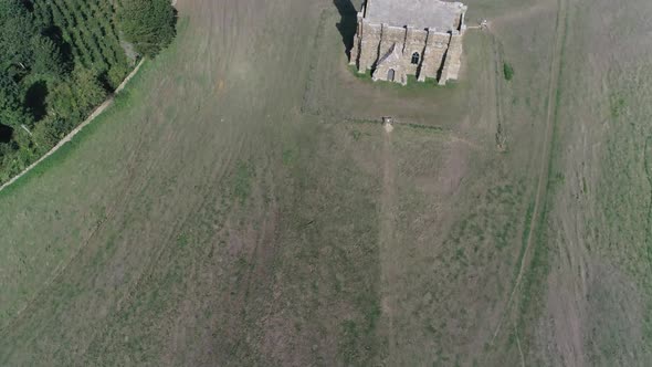 Forward tracking aerial over the top of St Catherine's Chapel in Dorset, England. Near Abbotsbury. B