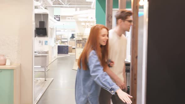 Beautiful Married Couple Choosing New Kitchen Interior in Market.