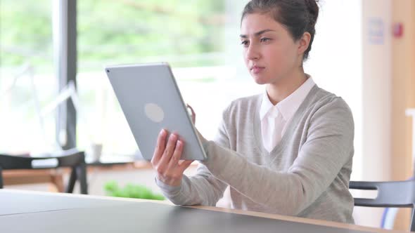 Indian Woman Having Failure on Tablet at Work 