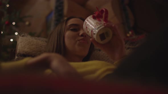 Low angle of a woman drinking from a mug