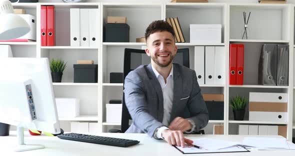 Director Siting in White Office, Smiling and Conducting Interview