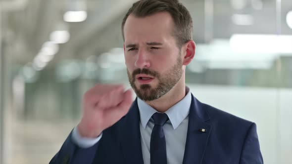 Portrait of Sick Businessman Coughing