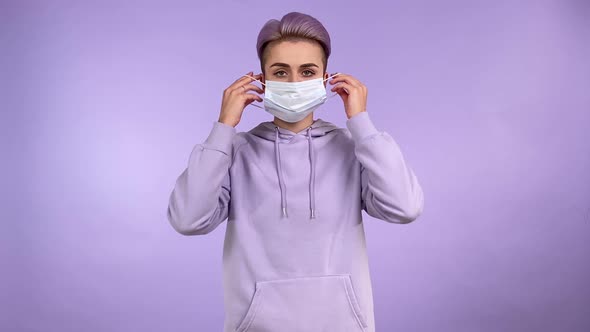Modern Young Woman Putting on Face Mask to Protect Virus Flu Isolated