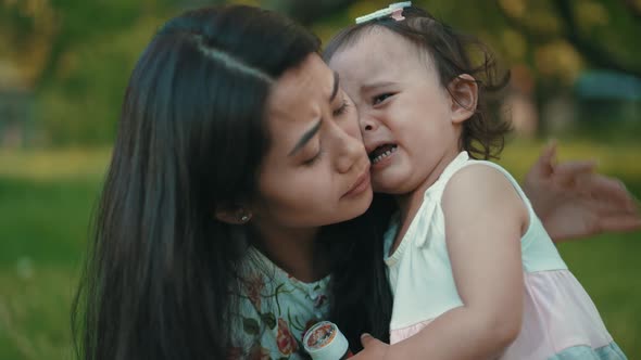 Mother Comforts Her Crying Daughter