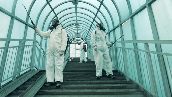 People Disinfect an Overhead Walkway.