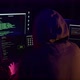A Hacker Hacks a Website Against the Backdrop of Police Flashing Lights - VideoHive Item for Sale