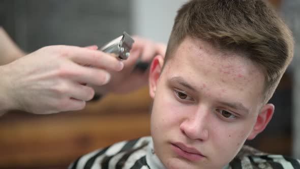 Young Man's Haircut in Barbershop