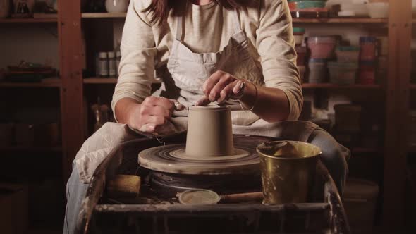 Pottery Workshop  Female Hands Cutting Off the Top Part of the Clay Pot Using a String