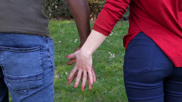 Interracial love,romance concept.Black man hand holding white woman hand