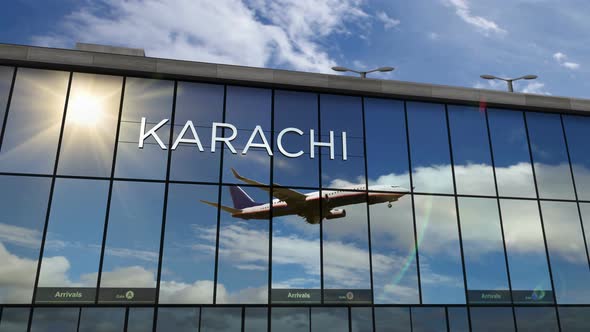 Airplane landing at Karachi Pakistan airport mirrored in terminal