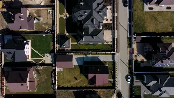 Aerial view of houses on housing estates, some with building on roof panels