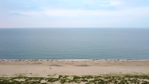 4K Aerial Drone Footage Flying Over Ocean at Scenic Coastal Beach, UK