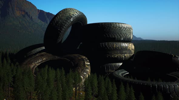 Concept of Environmental Pollution with Big Old Tires in Mountain Forest alt