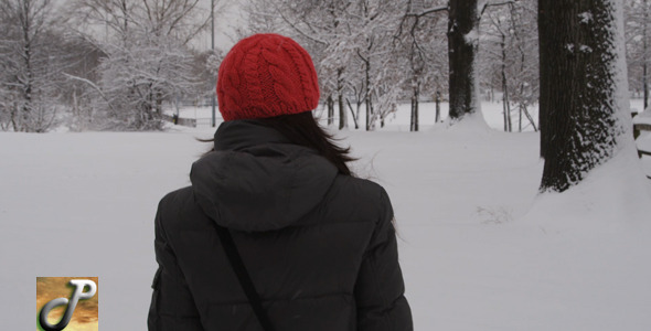 Woman With Red Hat Walking On The Snow