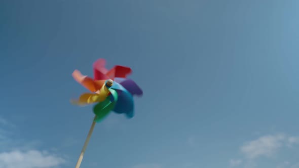 Colorful Paper Windmill Against the Blue Sky