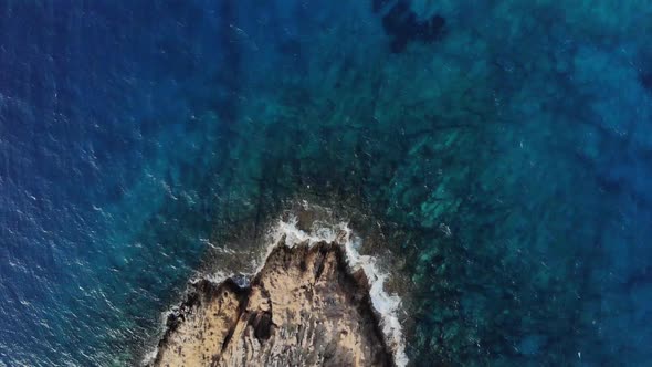 Aerial View. Waves Crashing Against Rocks. Sea Waves on Dangerous Rocks From a Bird's-eye View