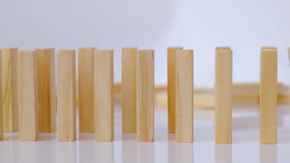 Domino Effect Row of Wooden Domino Falling Down on White Background