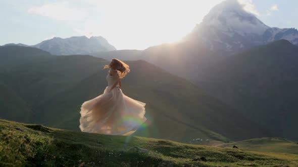 Beautiful Girl Dances in the Evening Against the Backdrop of the Mountains