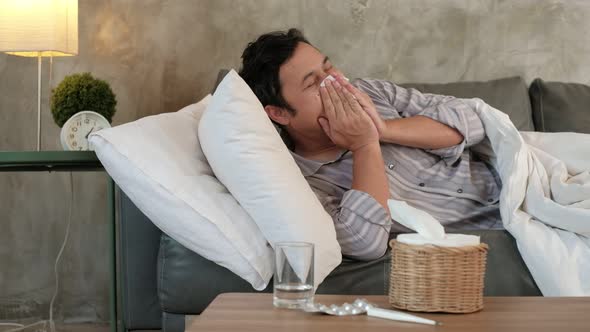 Illness Asian male worker absent from work and sick leave due to flu.