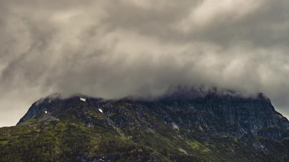 Rocky Mountain In Hemsedal, Norway With Peak Clad In Moving Clouds - timelapse - zoom-out shot