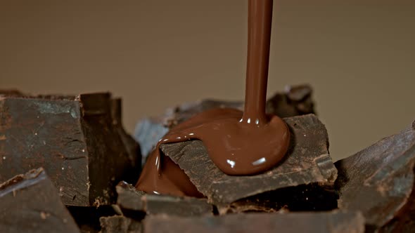 Super Slow Motion Shot of Pouring Melted Chocolate on Raw Chocolate Chunks at 1000 Fps