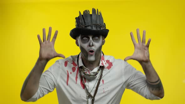 Sinister Man with Horrible Halloween Skeleton Makeup Making Faces, Looking at Camera Trying To Scare