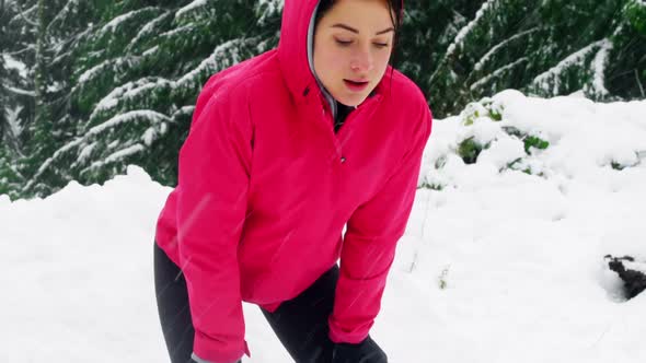 Tired woman taking a break while jogging