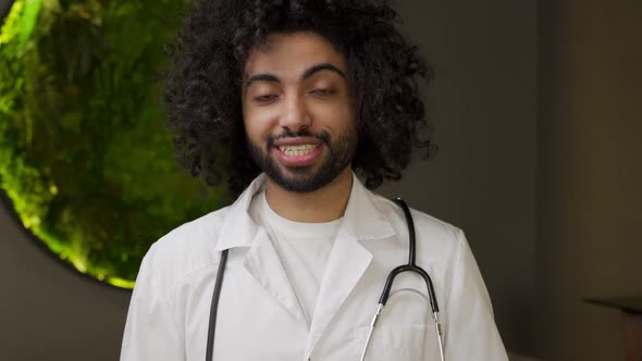 Arabian Doctor in Uniform with Stethoscope Talks to Camera