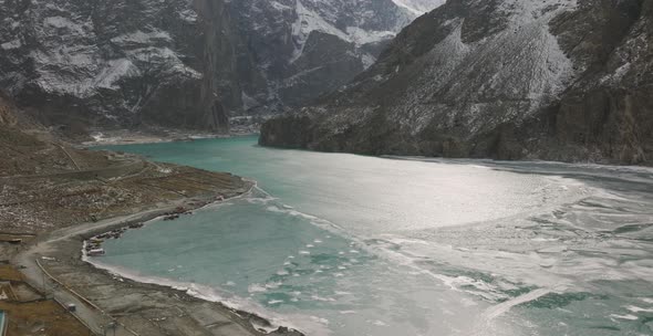 Aerial view of frozen lake between snowcapped mountain Attabad Lake is a lake located in the Gojal r