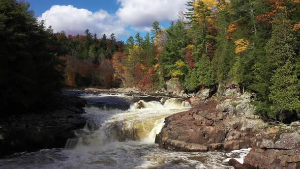 warterfalls and rapids in fall colored forest slow motion aerial