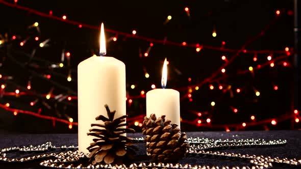 Two Big White Candles with Pine Cone for Christmas on Black, Bokeh, Light, Garland