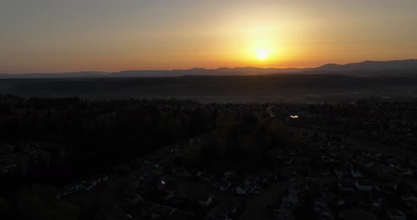 Orbiting aerial of the sunrise over the Cascade Mountain Range.